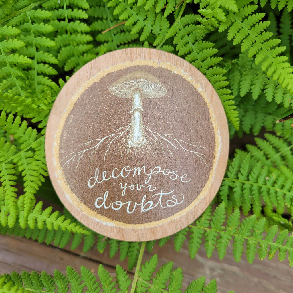 Colorful wooden sticker with mushroom and mycelial network -  decompose your doubts